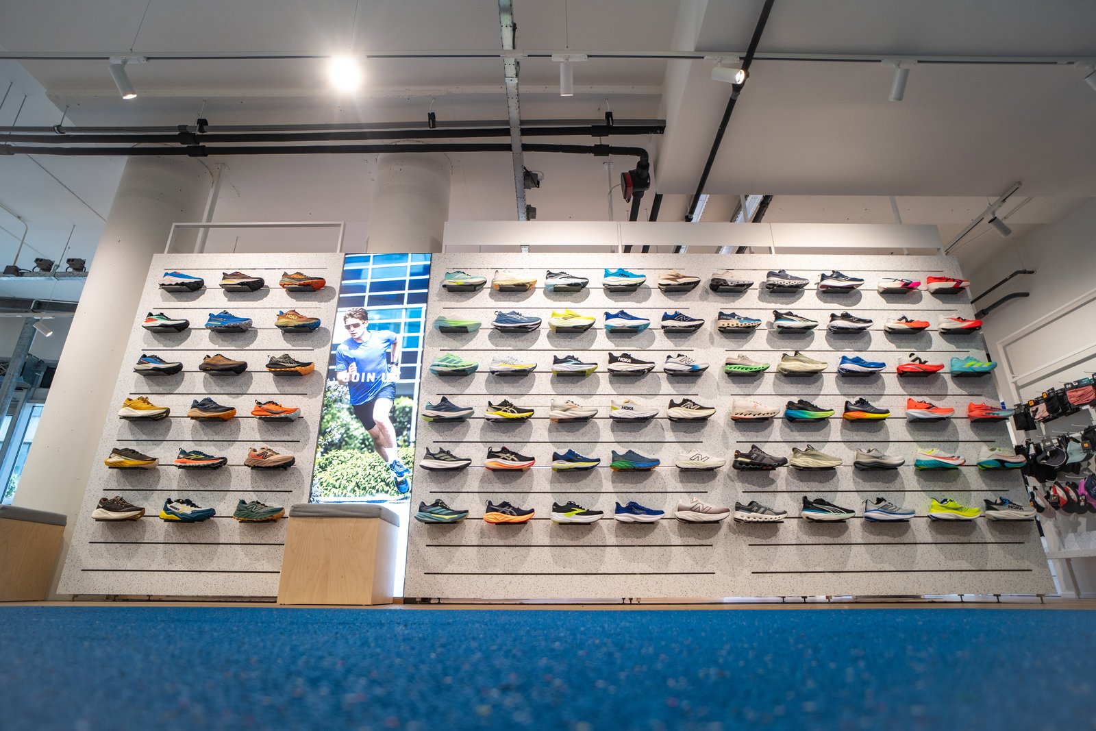 Wall of running shoes on display at Runnersworld Eindhoven, Netherlands.